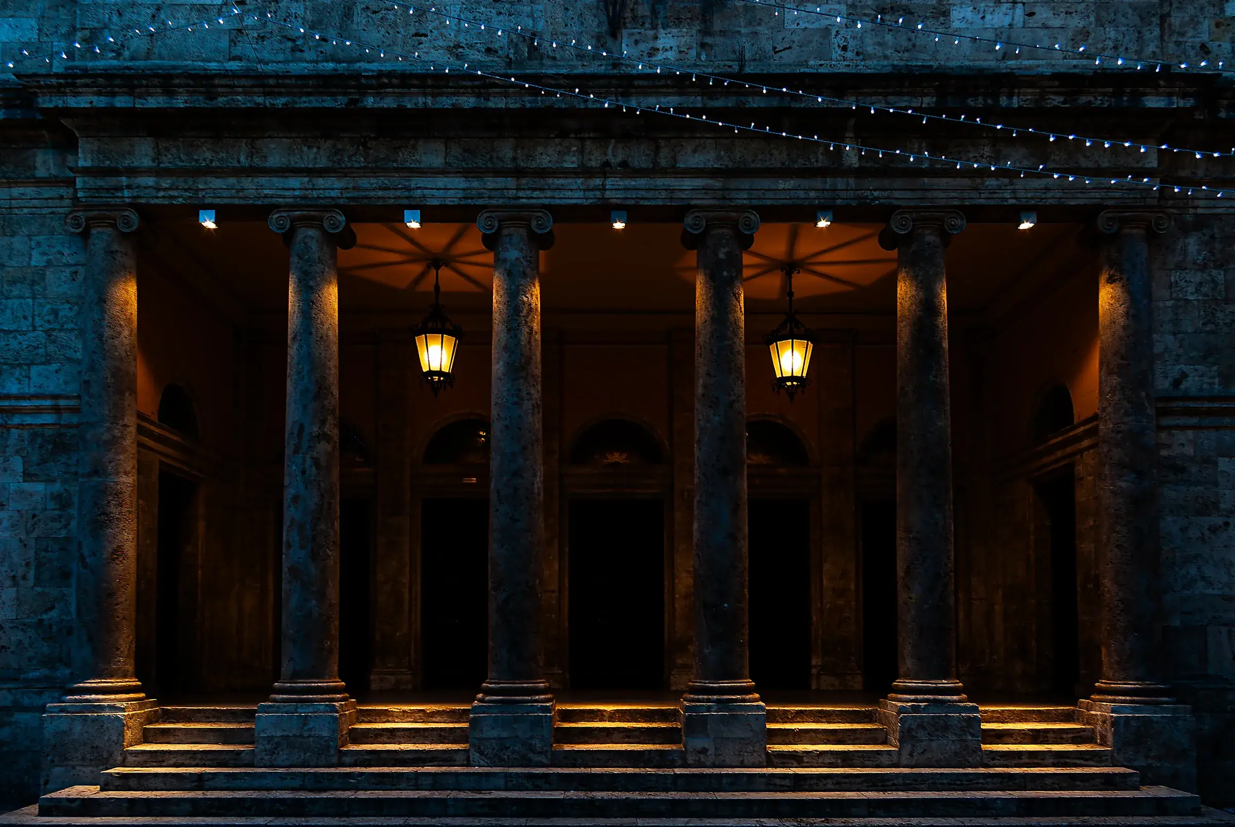 A lit portico at night in Ascoli Piceno, Italy.