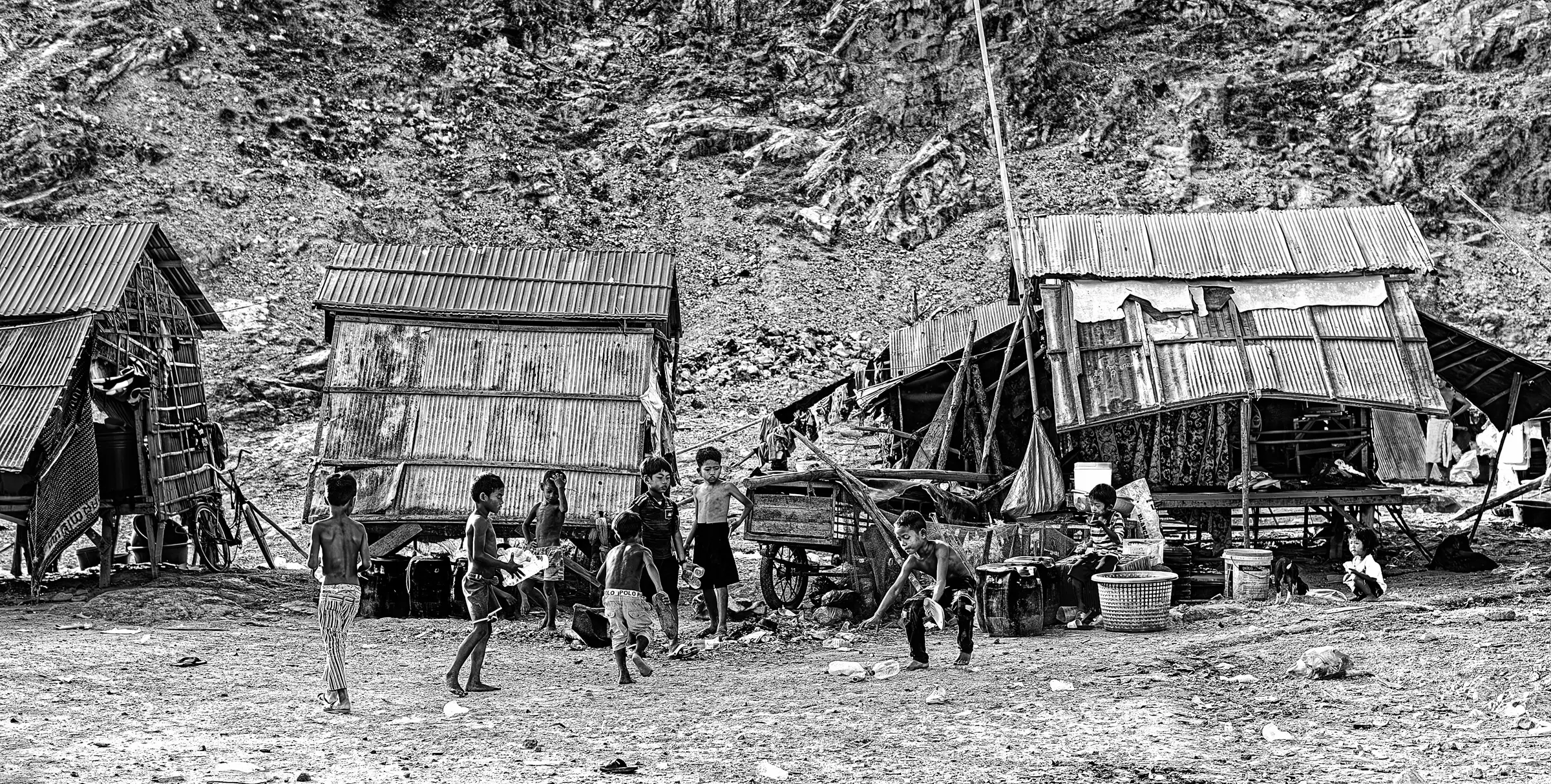 Children in Settlement Black-and-white photograph of children in a hillside settlement.
