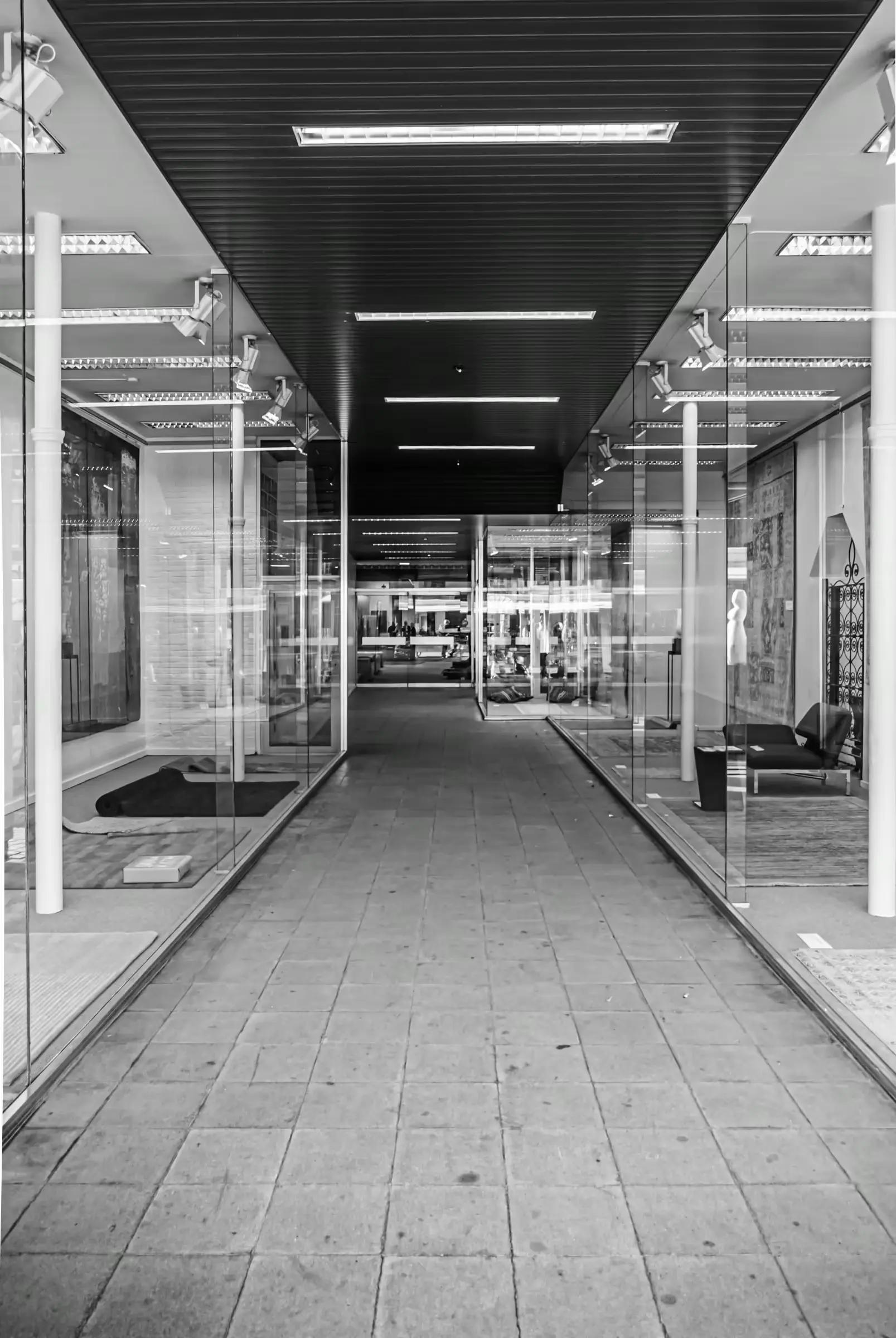 Black-and-white photograph of the geometric lines of a modern corridor in Mechelen, Belgium.