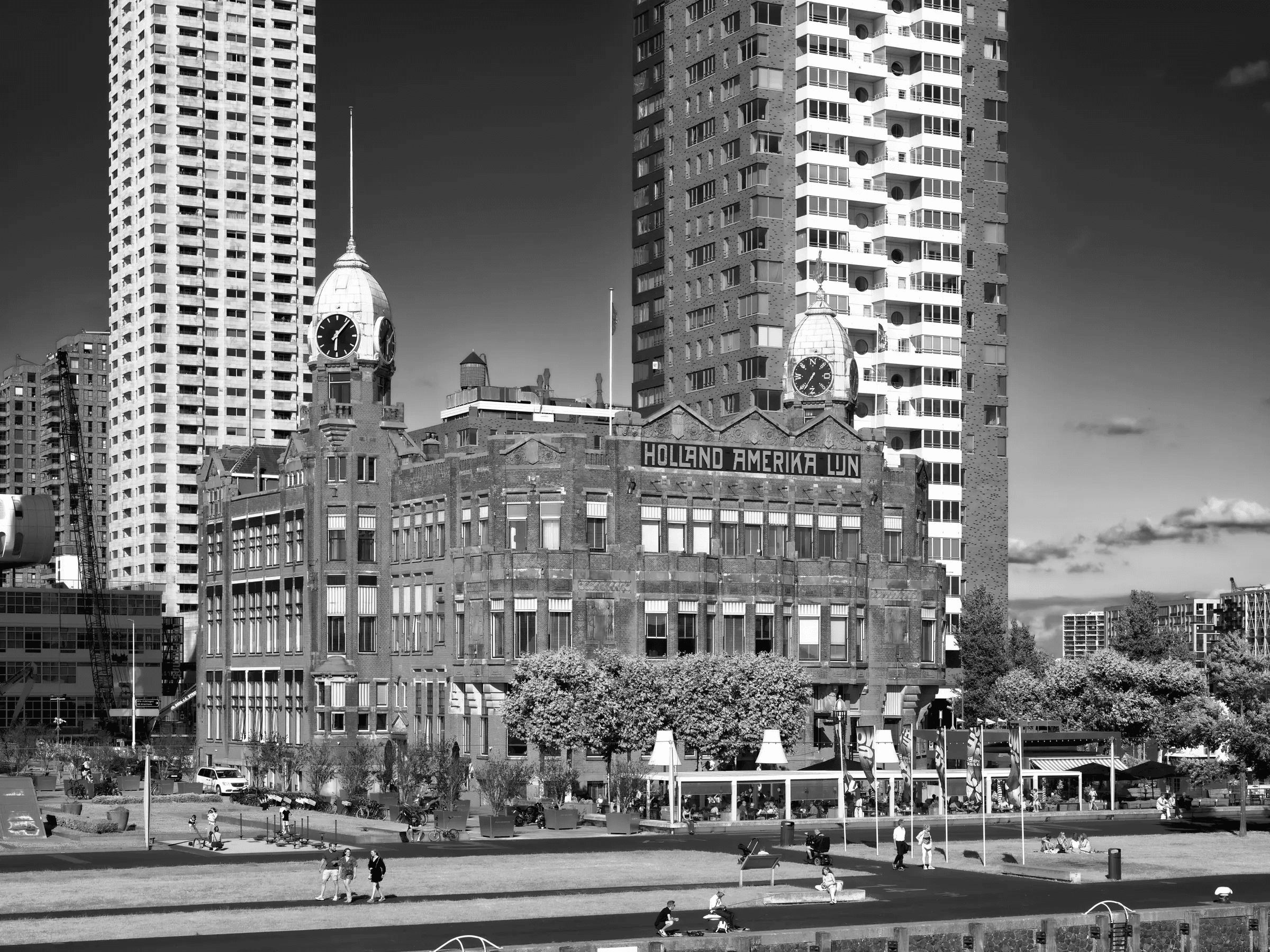 Holland-Amerika, Rotterdam Holland-Amerika building in Rotterdam framed by towers above a public lawn.
