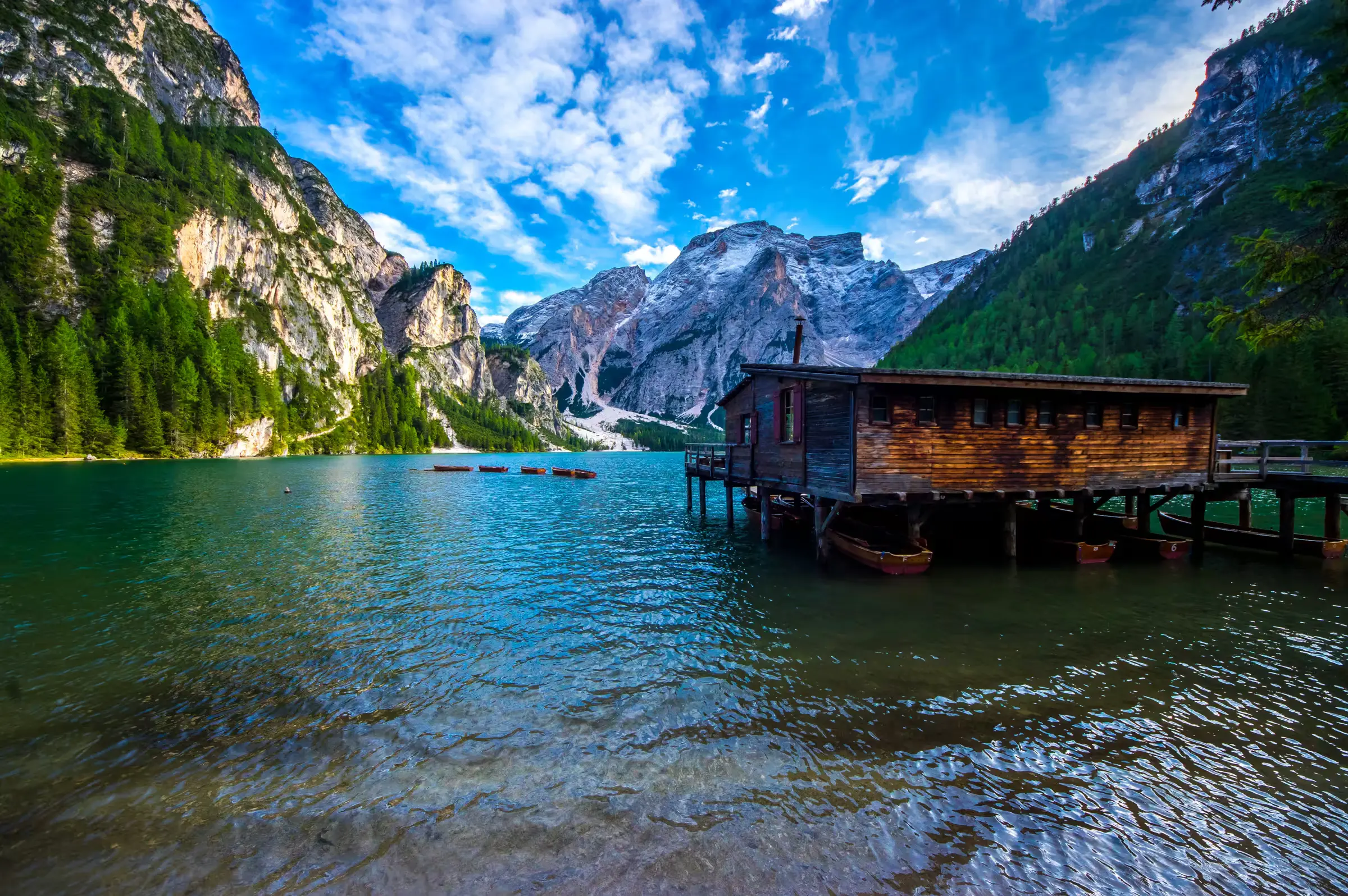 Lago di Braies Reflections Lago di Braies (Pragser Wildsee) with its wooden boathouse and the Dolomites behind, Italy.