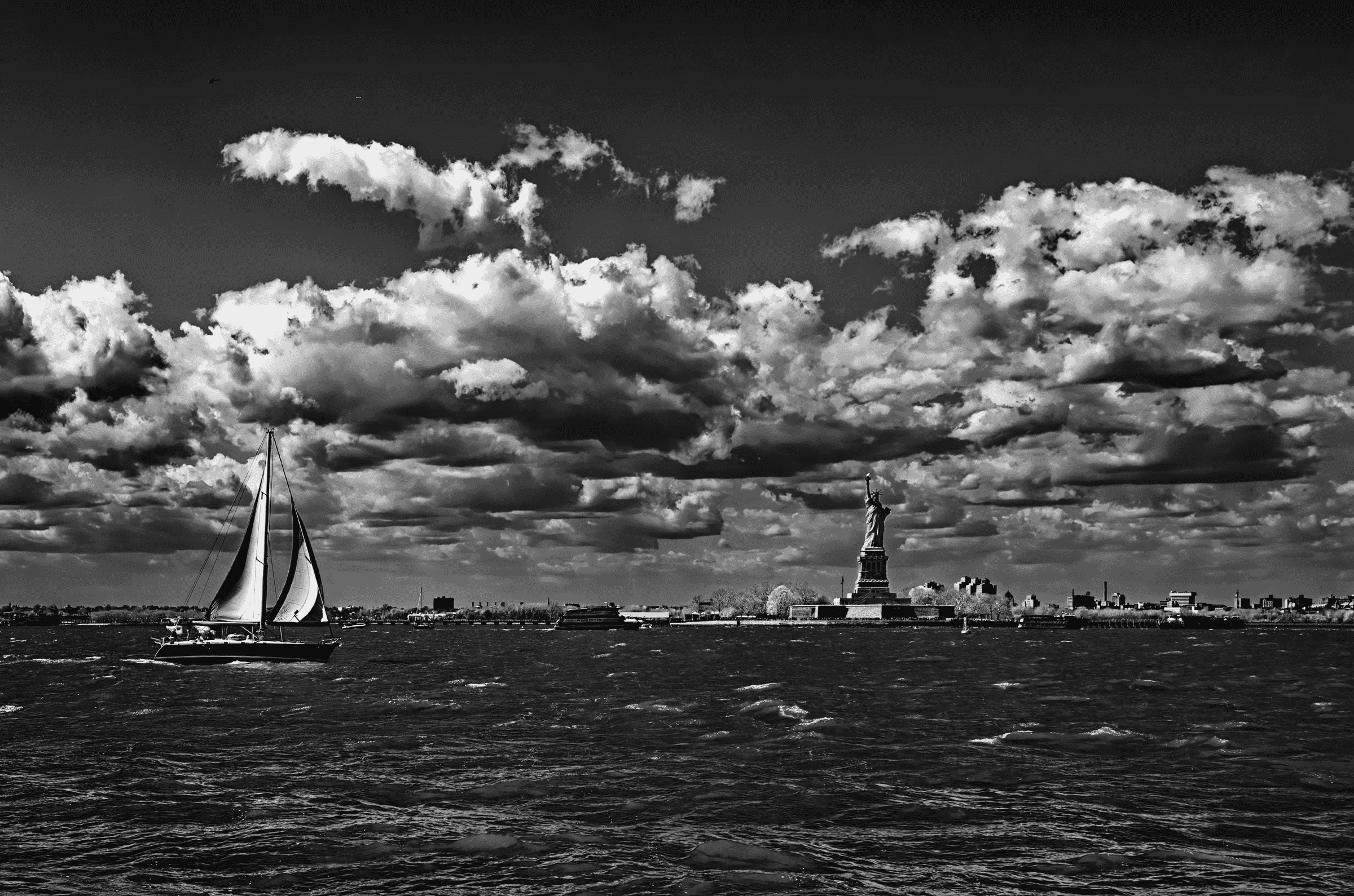 Cityscape with Sailboat NYC Statue Liberty Sailboat in New York Harbor.