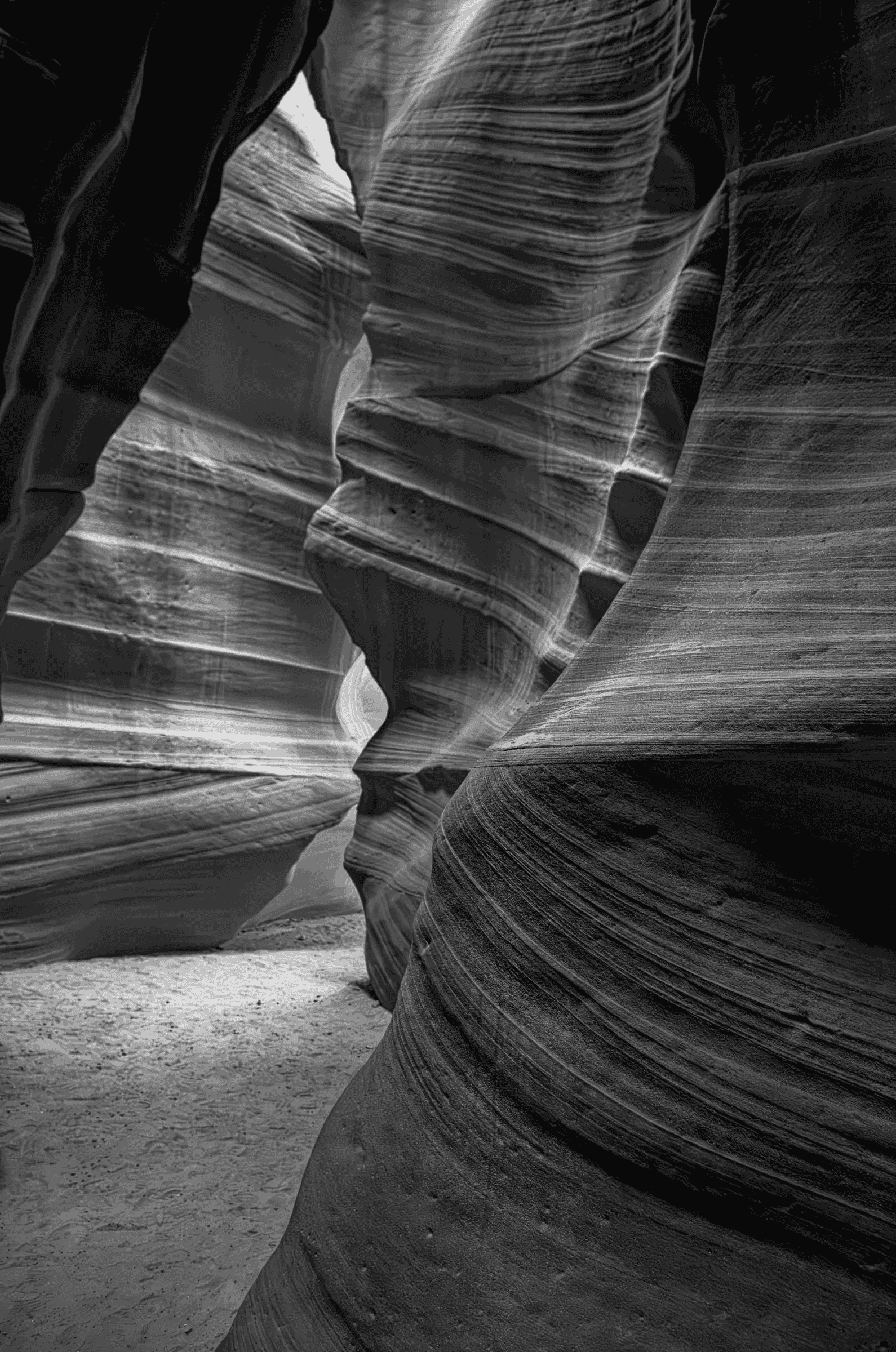 The Long Carving Monochrome view through the layered, curving sandstone walls of Antelope Canyon in Arizona.