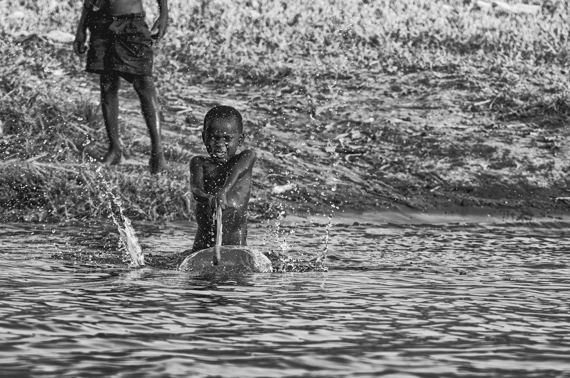 Splashing Fun, Uganda Splashing Fun in Uganda in daily life in monochrome.