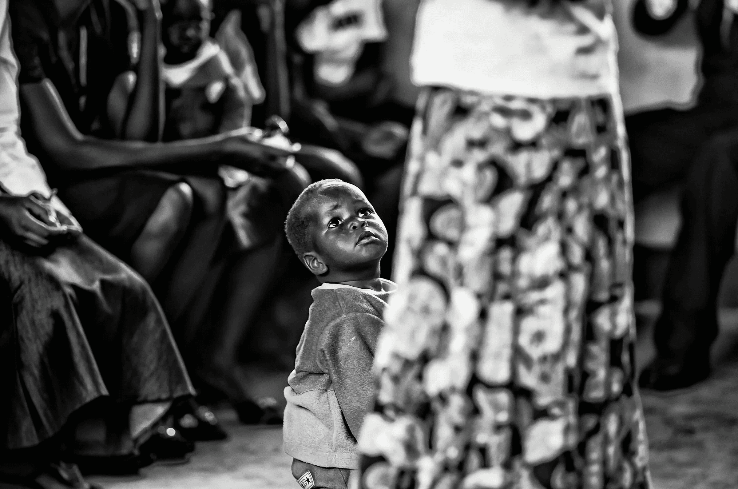 Child Looking Up, Uganda Child Looking Up in a quiet portrait in Uganda in monochrome.