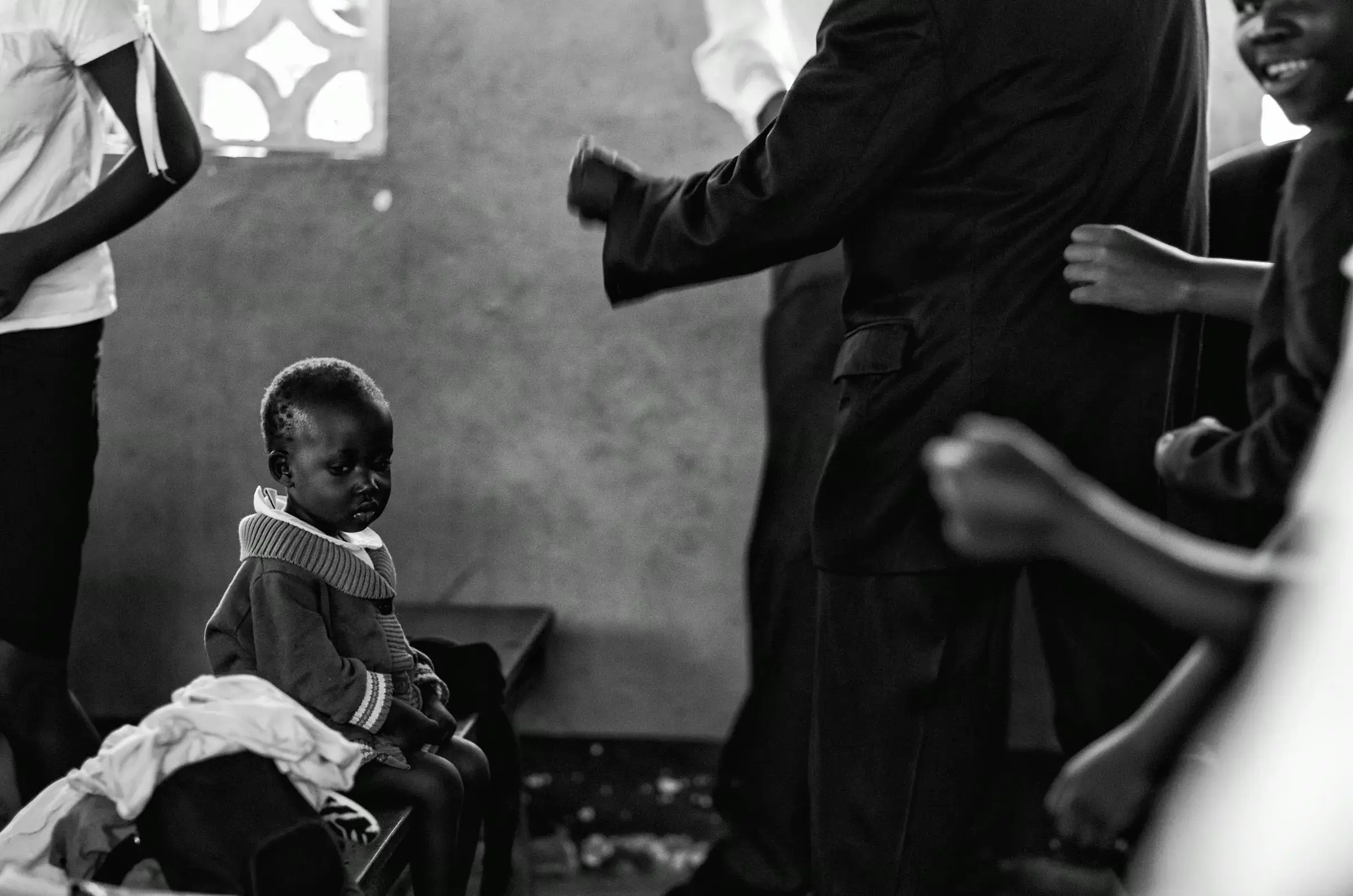 Black-and-white portrait of a child watching the camera in Uganda.