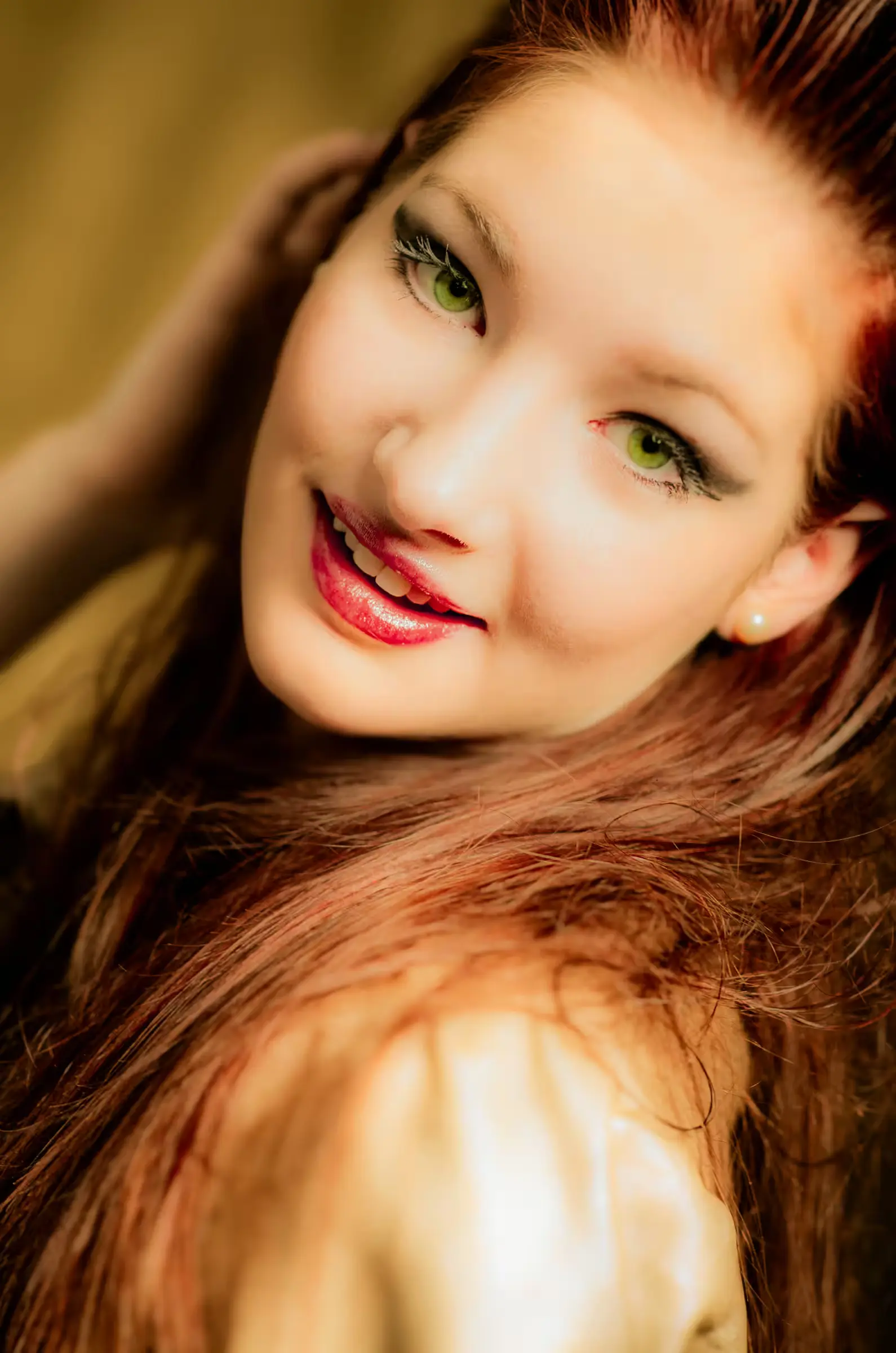 A young woman with long auburn hair and green eyes.