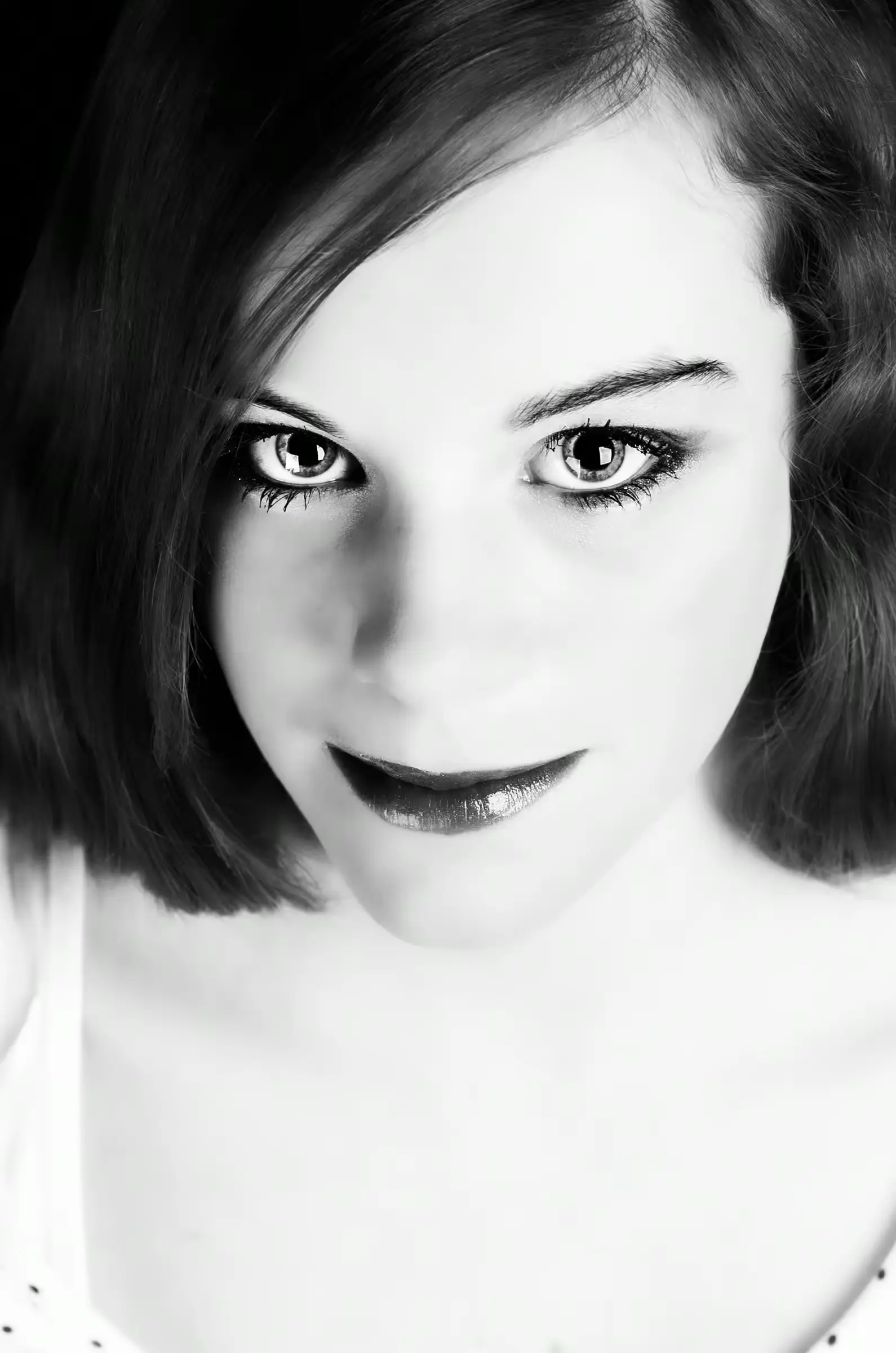 Black-and-white portrait of a woman looking directly into the camera.